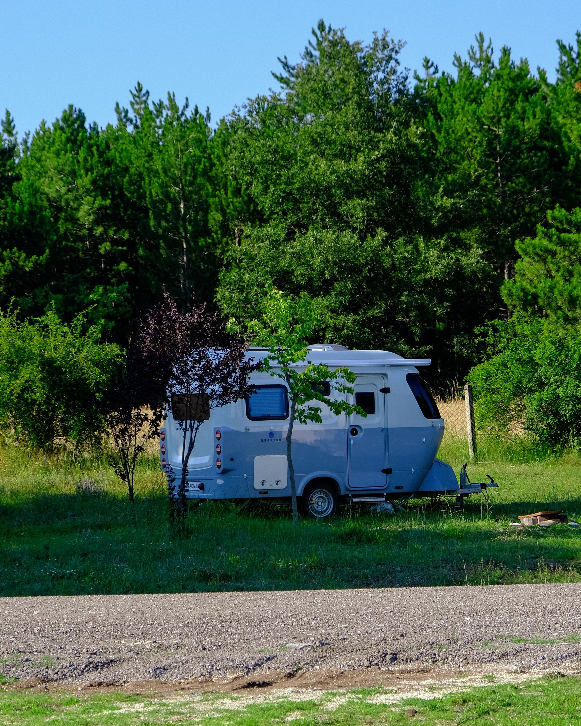 Serene caravan setup in lush Bilecik forest, perfect for nature getaways.